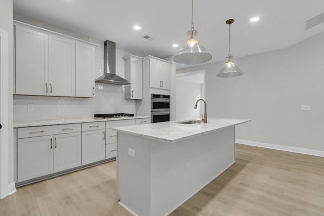395 Wappoo Trace Ln, Summerville, SC 29486 - kitchen with wall chimney range hood, a sink, light wood-style floors, double oven, and tasteful backsplash