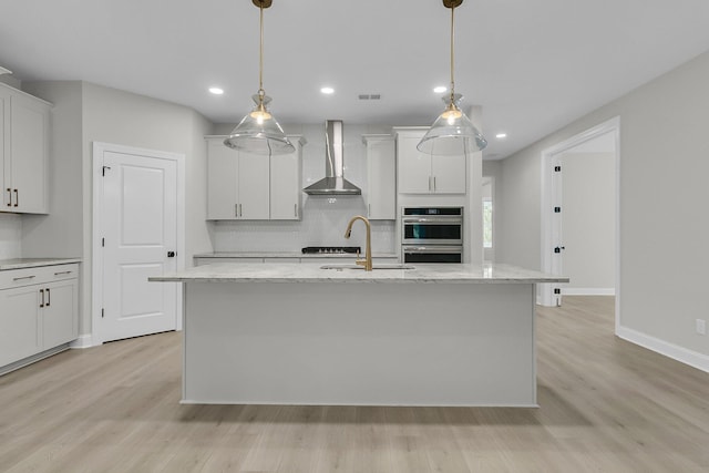 395 Wappoo Trace Ln, Summerville, SC 29486 - kitchen with wall chimney range hood, a sink, backsplash, stainless steel double oven, and light wood finished floors