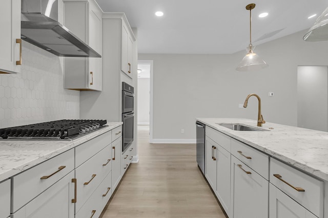 395 Wappoo Trace Ln, Summerville, SC 29486 - kitchen with wall chimney range hood, a sink, stainless steel appliances, decorative backsplash, and light wood-style floors