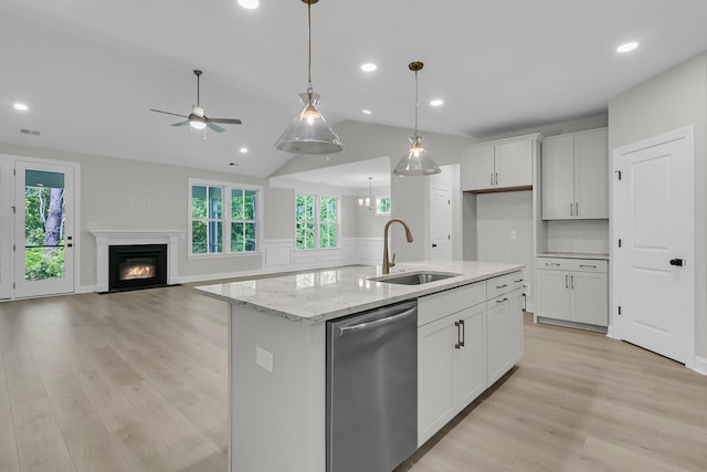 395 Wappoo Trace Ln, Summerville, SC 29486 - kitchen featuring dishwasher, a sink, a ceiling fan, white cabinetry, and a glass covered fireplace