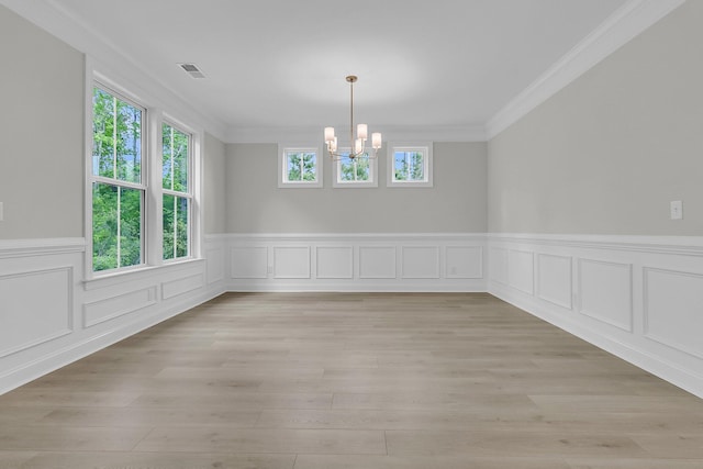 395 Wappoo Trace Ln, Summerville, SC 29486 - unfurnished dining area featuring a chandelier, plenty of natural light, ornamental molding, wainscoting, and light wood finished floors