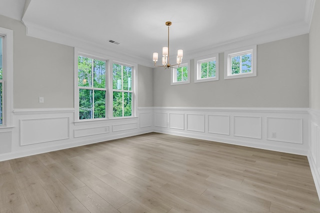 395 Wappoo Trace Ln, Summerville, SC 29486 - spare room featuring a chandelier, ornamental molding, healthy amount of natural light, a wainscoted wall, and light wood-style flooring