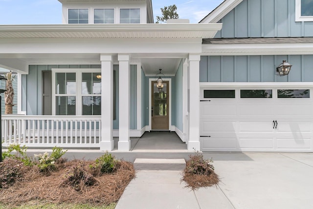 395 Wappoo Trace Ln, Summerville, SC 29486 - property entrance with board and batten siding, covered porch, a garage, and driveway