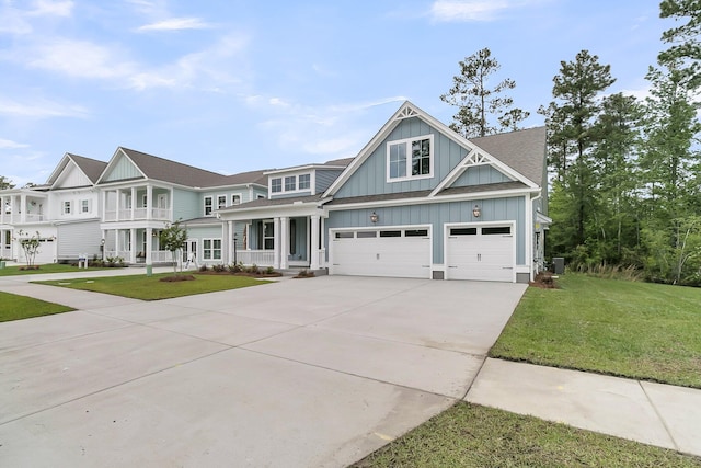 395 Wappoo Trace Ln, Summerville, SC 29486 - view of front of home featuring board and batten siding, concrete driveway, a front yard, an attached garage, and central AC unit