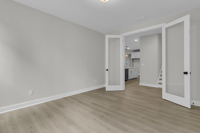 395 Wappoo Trace Ln, Summerville, SC 29486 - empty room with light wood-type flooring, baseboards, stairs, recessed lighting, and a sink