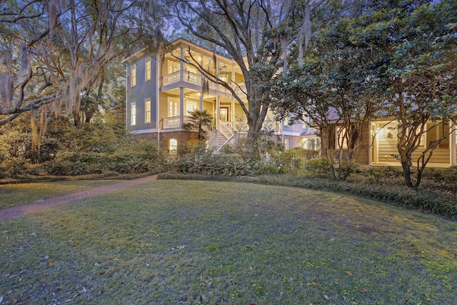 2206 Weepoolow Trl, Charleston, SC 29407 - view of front of property featuring stairs, a front yard, a porch, and a balcony