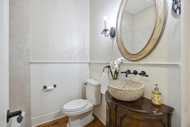 2206 Weepoolow Trl, Charleston, SC 29407 - bathroom with a wainscoted wall, toilet, vanity, and wood finished floors