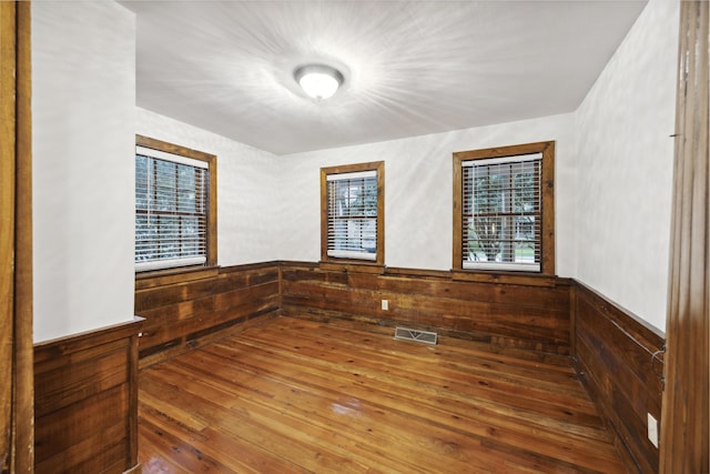 2206 Weepoolow Trl, Charleston, SC 29407 - spare room with wood walls, a wainscoted wall, and hardwood / wood-style floors