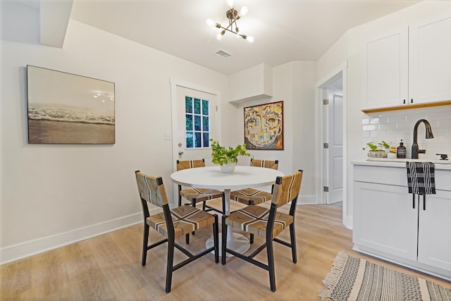 2608 Seymour Ave, North Charleston, SC 29405 - dining space with light wood-type flooring and a chandelier