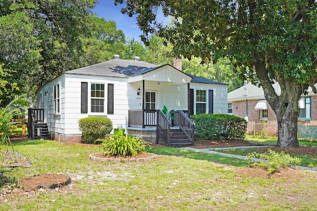 2608 Seymour Ave, North Charleston, SC 29405 - bungalow-style home with a chimney and a front lawn