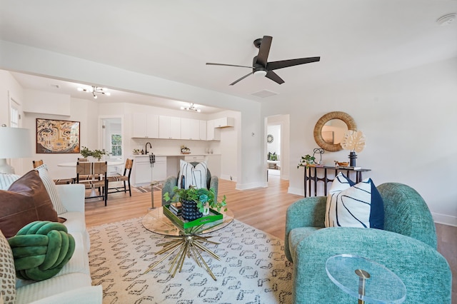 2608 Seymour Ave, North Charleston, SC 29405 - living room featuring light wood-style flooring, ceiling fan, and a chandelier