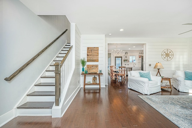 interior space with hardwood / wood-style flooring and wood walls