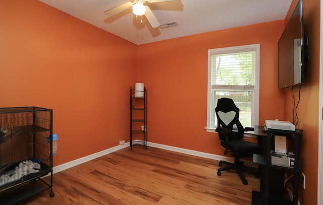 home office with ceiling fan and hardwood / wood-style floors