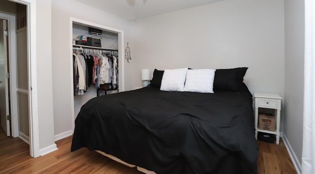 bedroom featuring hardwood / wood-style floors and a closet