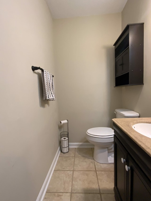 bathroom featuring toilet, vanity, and tile patterned floors