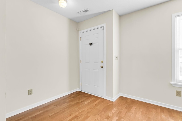 foyer with a wealth of natural light and light wood-type flooring