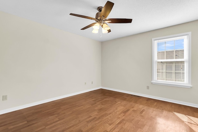 unfurnished room with hardwood / wood-style floors, ceiling fan, and a textured ceiling