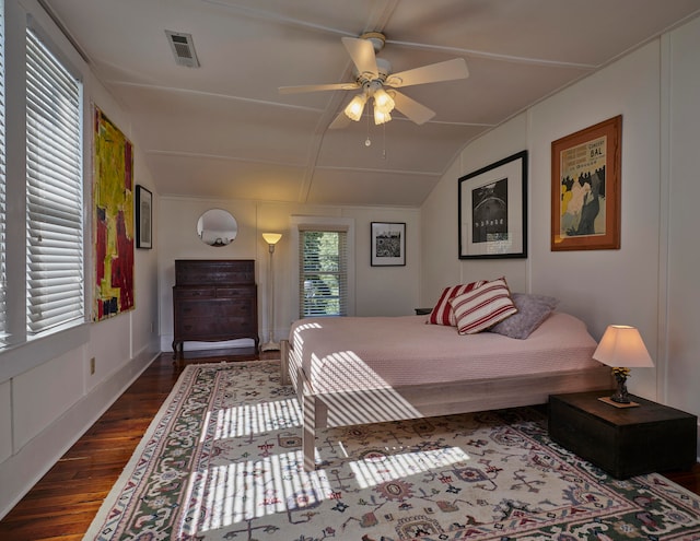 bedroom featuring dark hardwood / wood-style flooring, vaulted ceiling, and ceiling fan