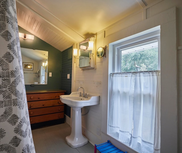 bathroom featuring lofted ceiling