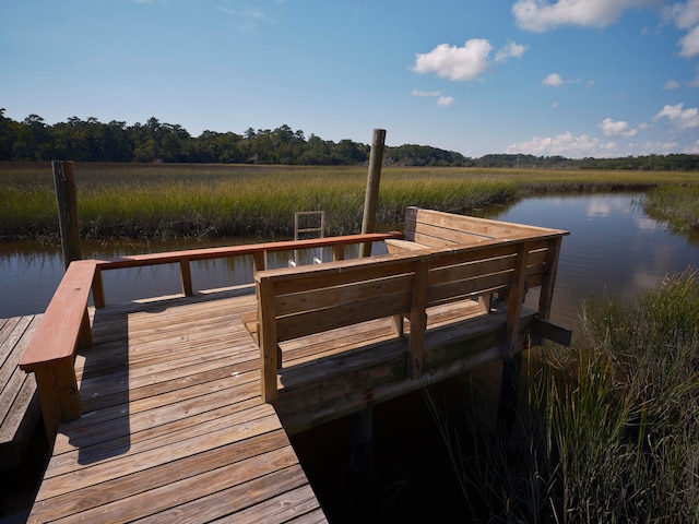 dock area with a water view and a rural view