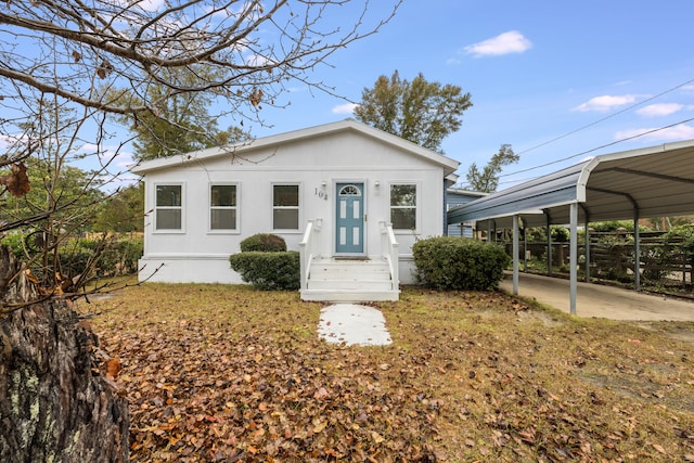 view of front of property featuring a carport