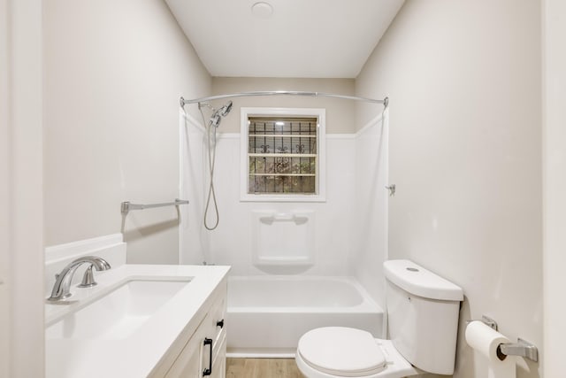 full bathroom with hardwood / wood-style floors, vanity, toilet, and shower / bathing tub combination