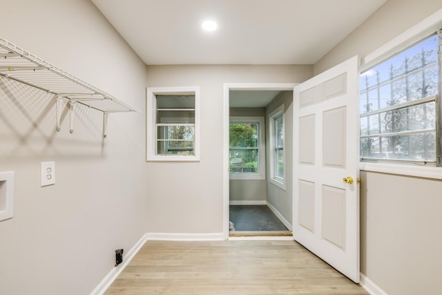 laundry room with light hardwood / wood-style floors