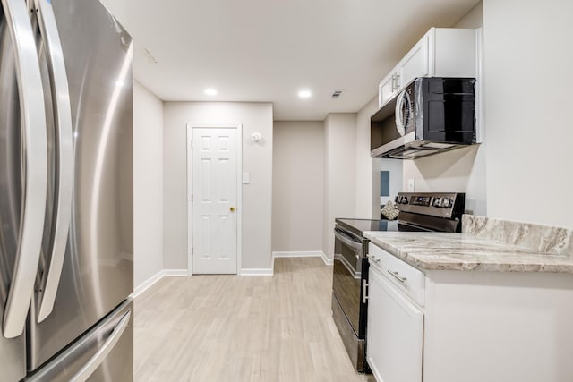 kitchen featuring light stone counters, white cabinets, light hardwood / wood-style floors, and appliances with stainless steel finishes