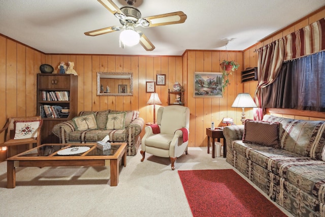 carpeted living room featuring crown molding and ceiling fan