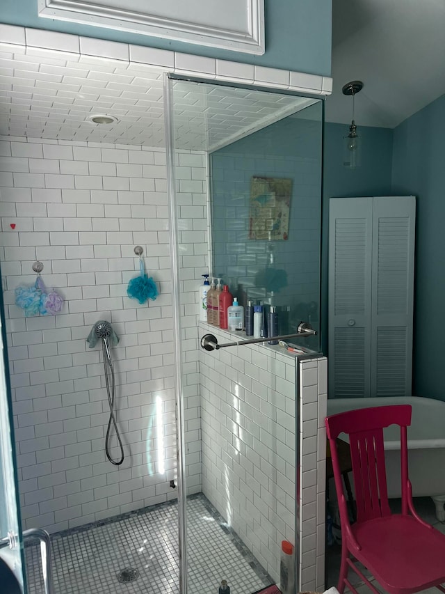 bathroom with tile patterned flooring and walk in shower