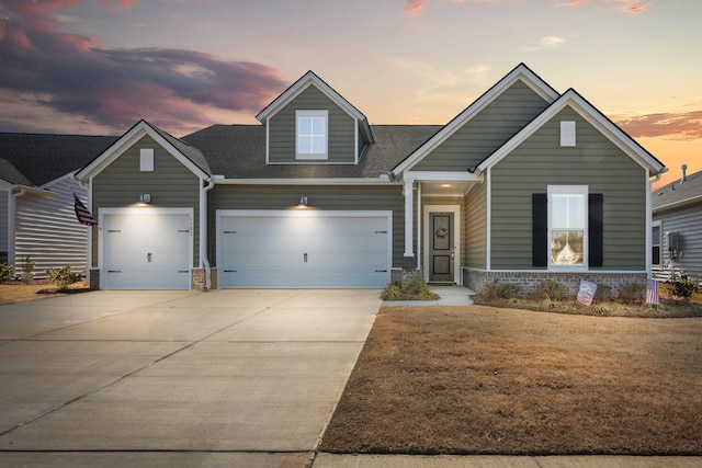 craftsman house with an attached garage, a shingled roof, brick siding, driveway, and a lawn