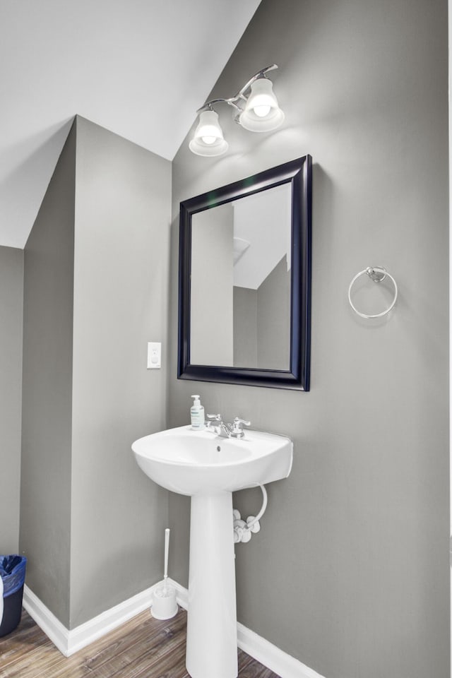 bathroom with baseboards and wood finished floors