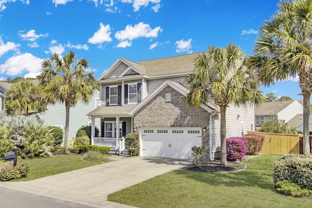 view of front of property featuring a porch, concrete driveway, a front lawn, and fence