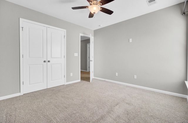 unfurnished bedroom with a closet, baseboards, visible vents, and carpet floors