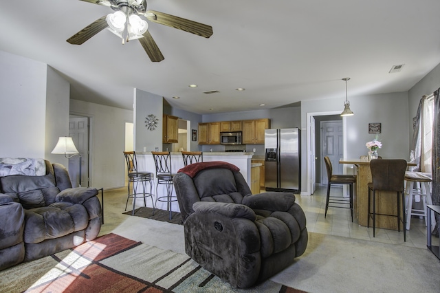 carpeted living room with ceiling fan