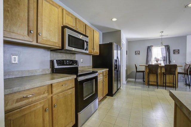 kitchen with pendant lighting and stainless steel appliances