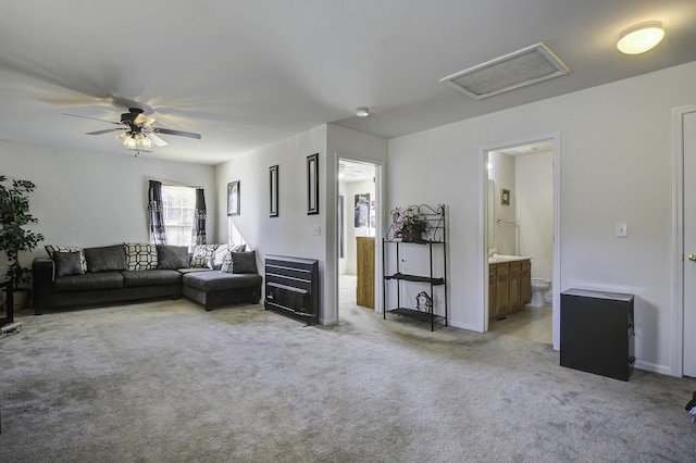 living room featuring ceiling fan and light carpet