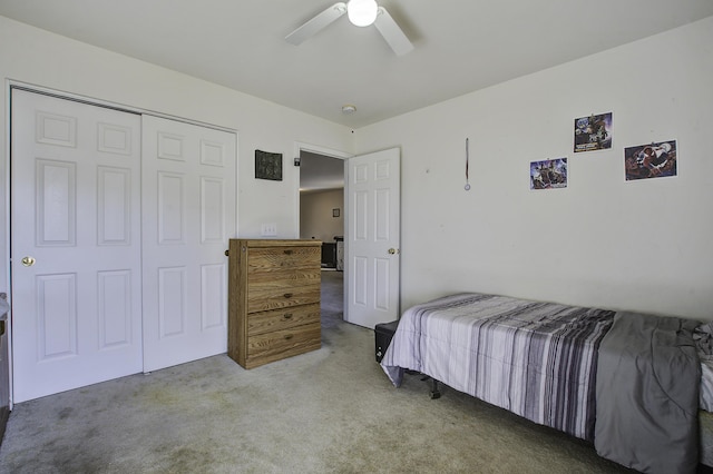 bedroom featuring ceiling fan, a closet, and light carpet