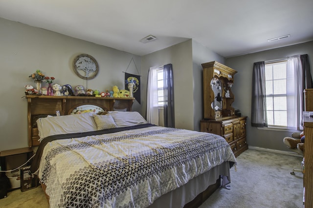 carpeted bedroom featuring multiple windows