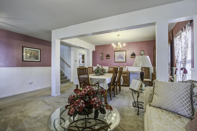 dining room with light carpet and a notable chandelier