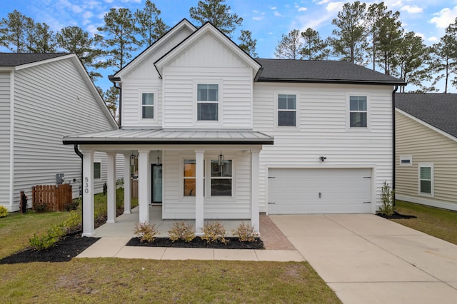 view of front of home with a porch, a front lawn, and a garage