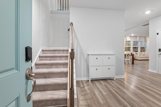 staircase featuring hardwood / wood-style floors