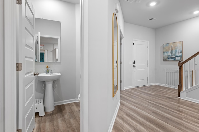 interior space featuring toilet and hardwood / wood-style flooring