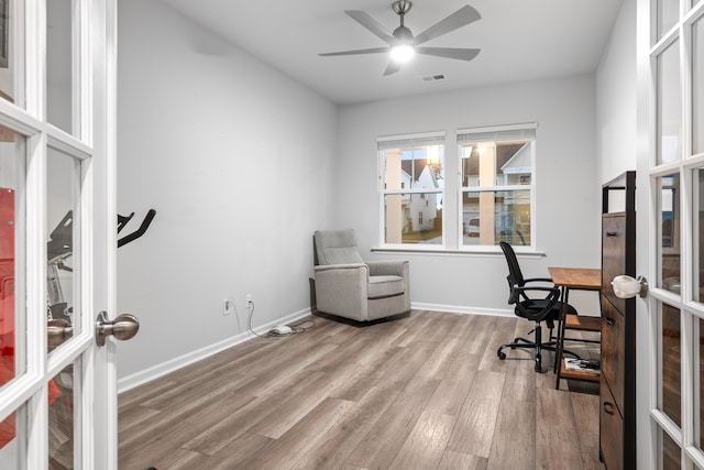 office featuring ceiling fan, french doors, and light hardwood / wood-style floors