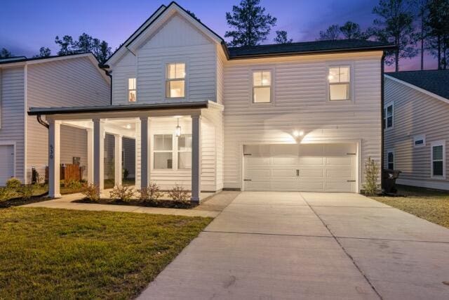 view of front of home featuring a garage and a yard