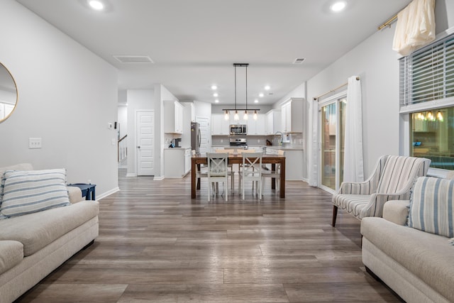 living room with sink and hardwood / wood-style flooring