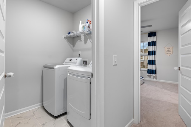 laundry area with washer and clothes dryer and light colored carpet