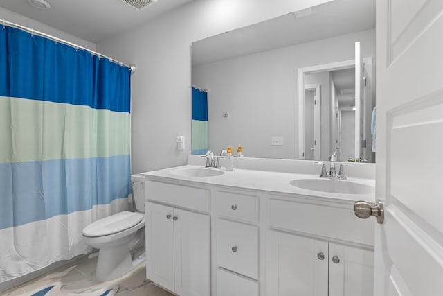 bathroom featuring curtained shower, vanity, and toilet