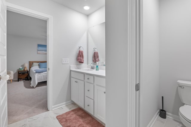 bathroom featuring toilet and vanity