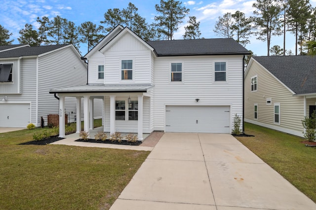 view of front of home featuring a front yard, a garage, and covered porch